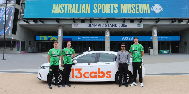 Frame 375 13cabs driver and players in front of 13cabs car